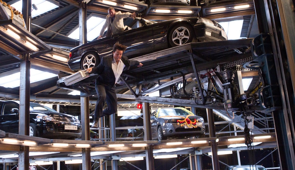 Michael Nyqvist plays Hendricks (upper) and Tom Cruise plays Ethan Hunt (jumping) in MISSION: IMPOSSIBLE – GHOST PROTOCOL, from Paramount Pictures and Skydance Productions.